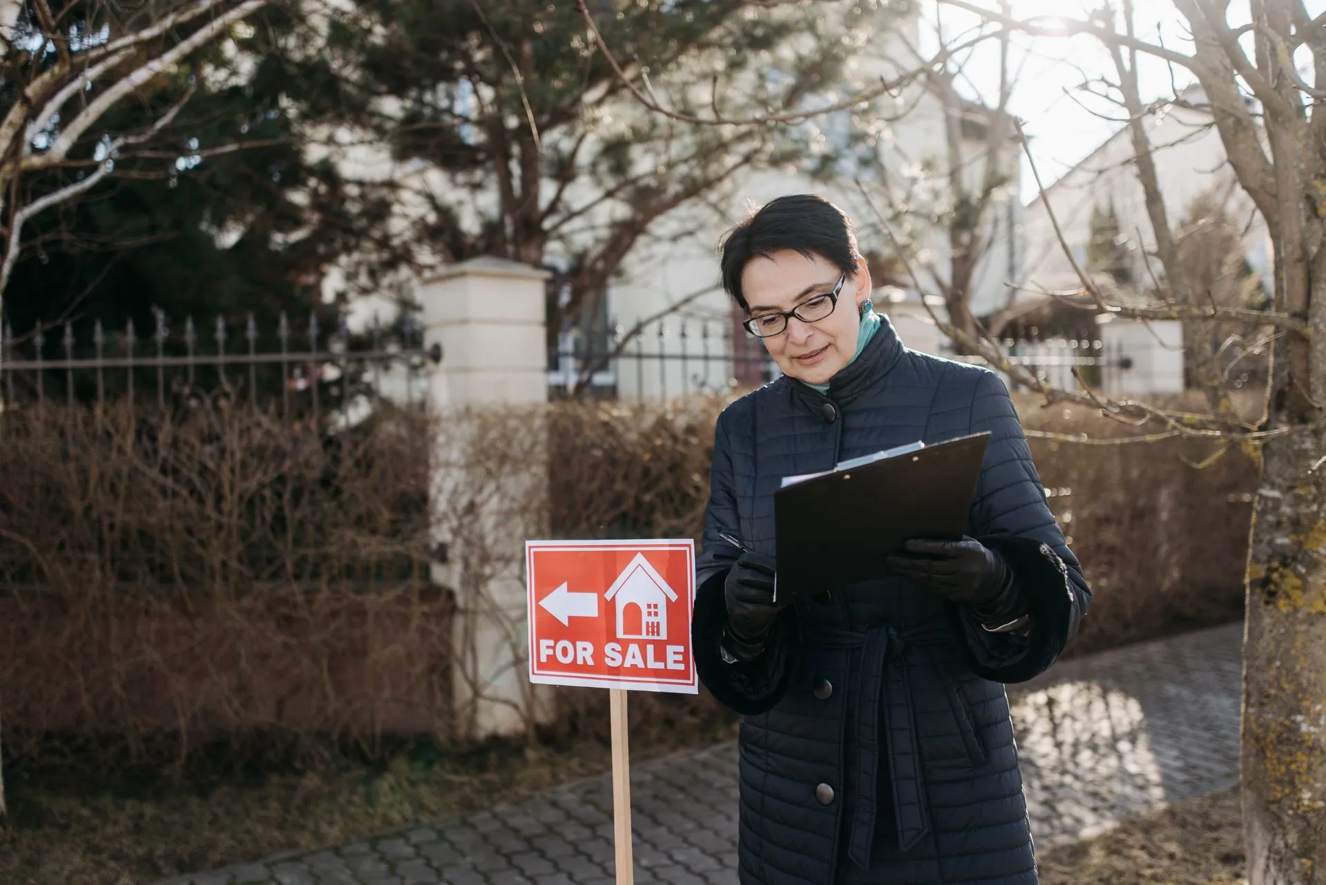 Agents in hard hats inspecting a property exterior