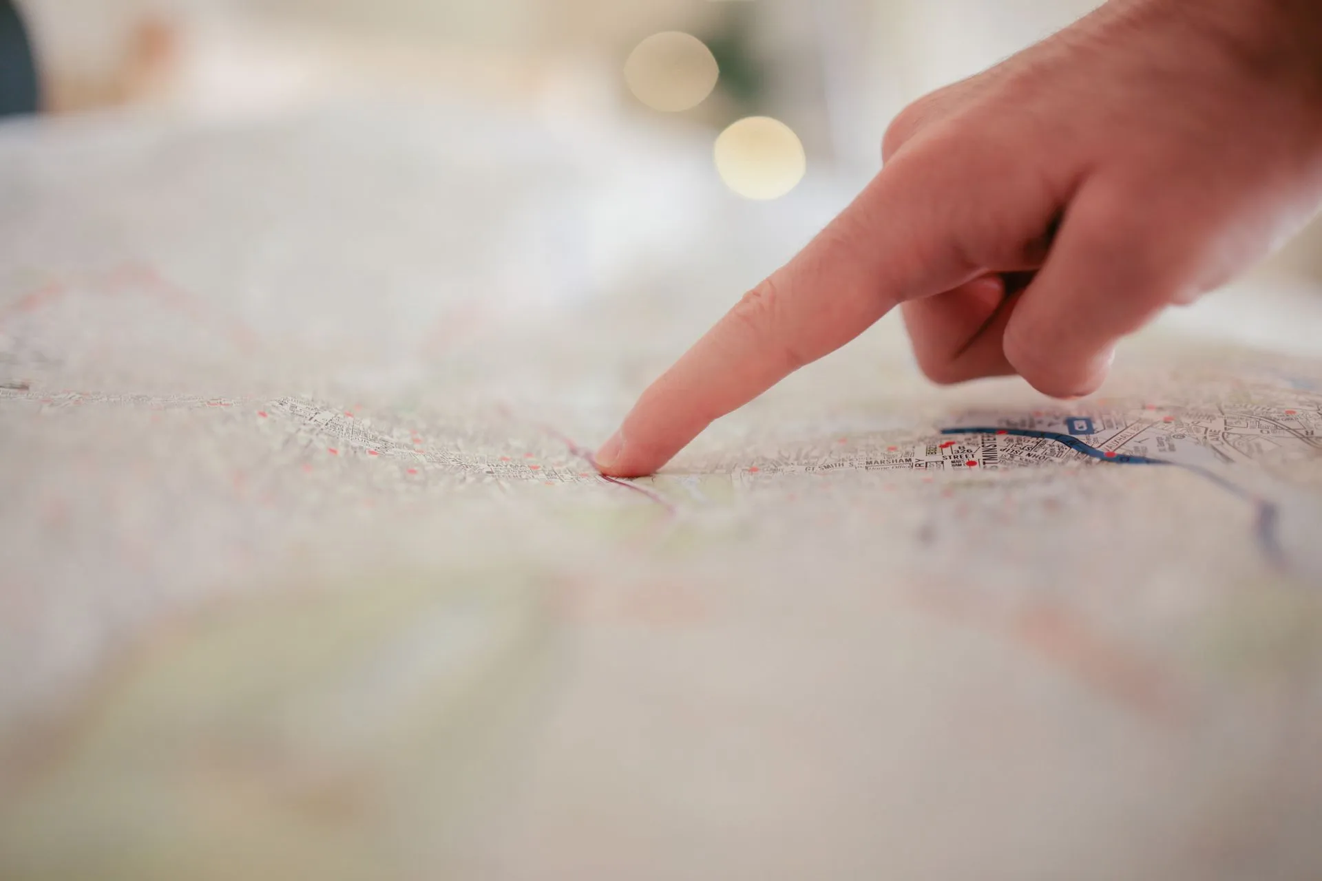 Hand pointing at a survey map